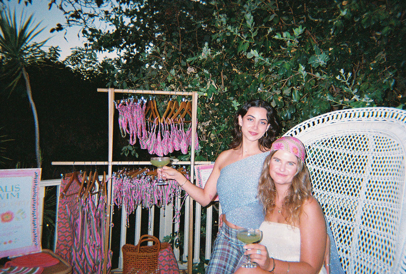 Drinking margaritas with my best friend at my swimwear brand launch event. We are sitting in front of my first collection.